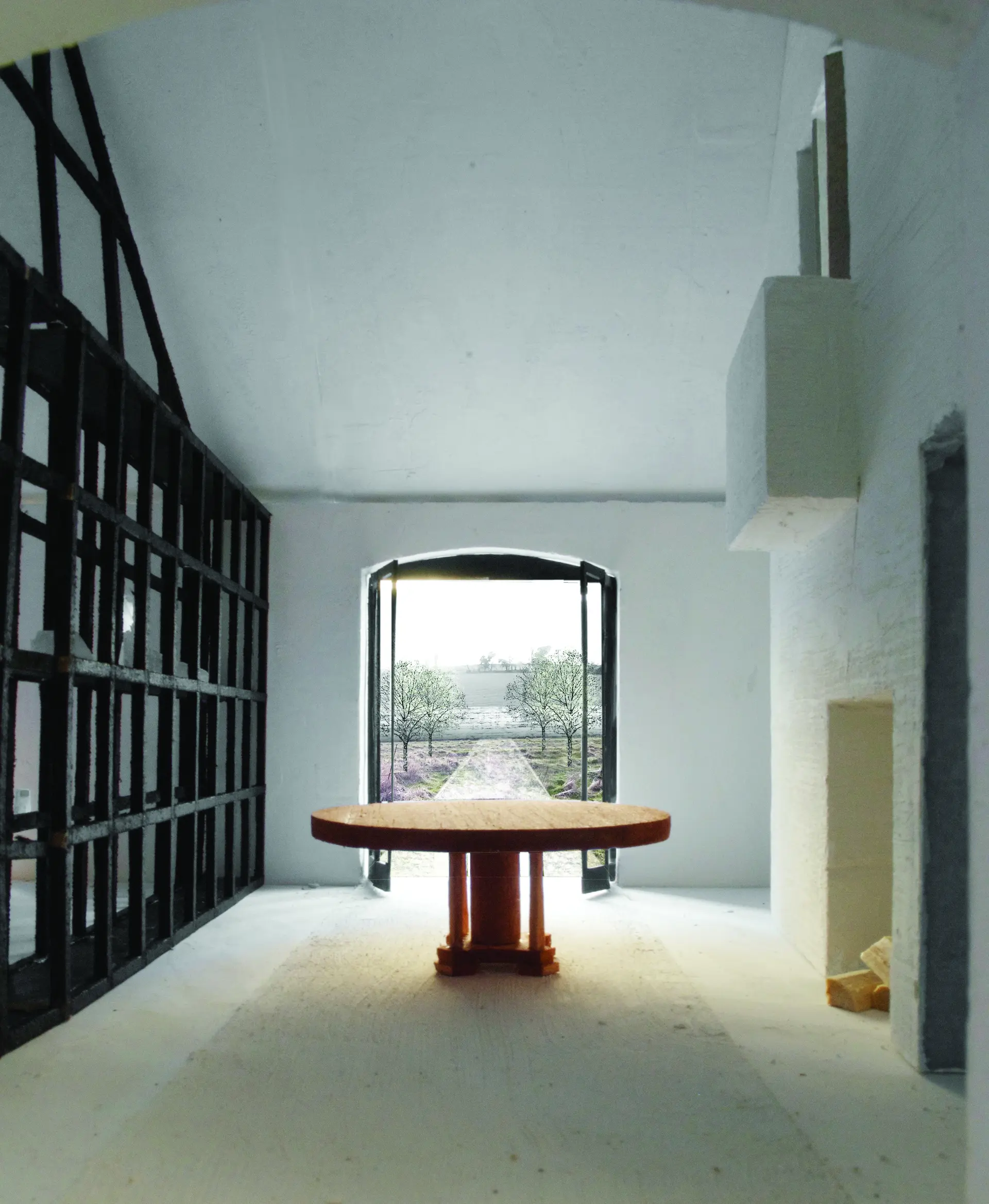 View through dining room 'carriageway' to the kitchen garden, with the vitrine to the left and fireplace and balcony to the right